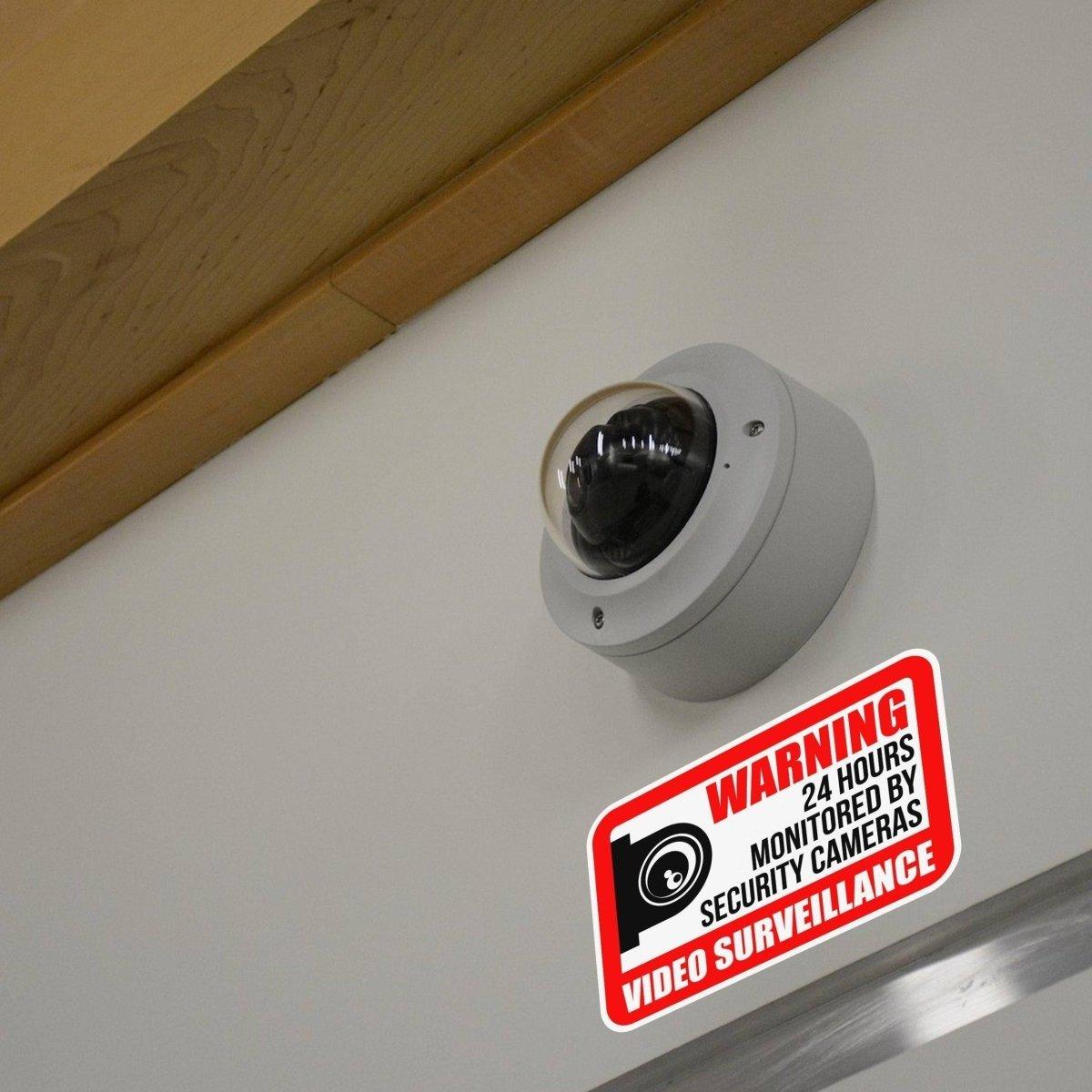 Weatherproof security camera installed with a warning sign for video surveillance protection.
