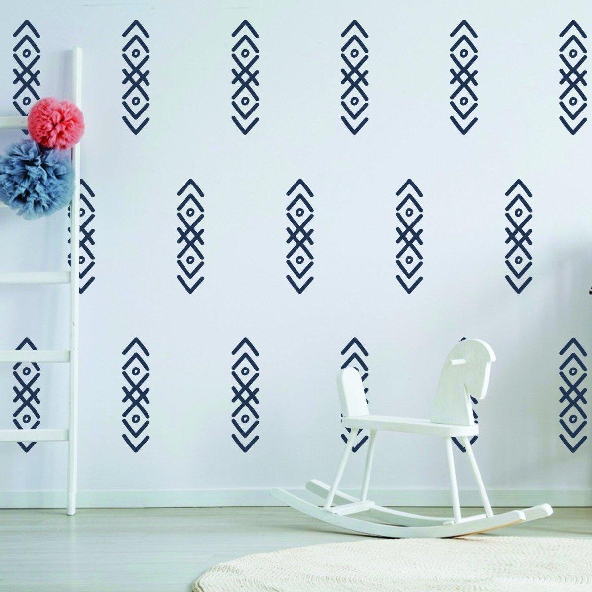 100x arrow wall stickers in navy blue on white wall, adding fun decor to a child's room with a rocking chair.