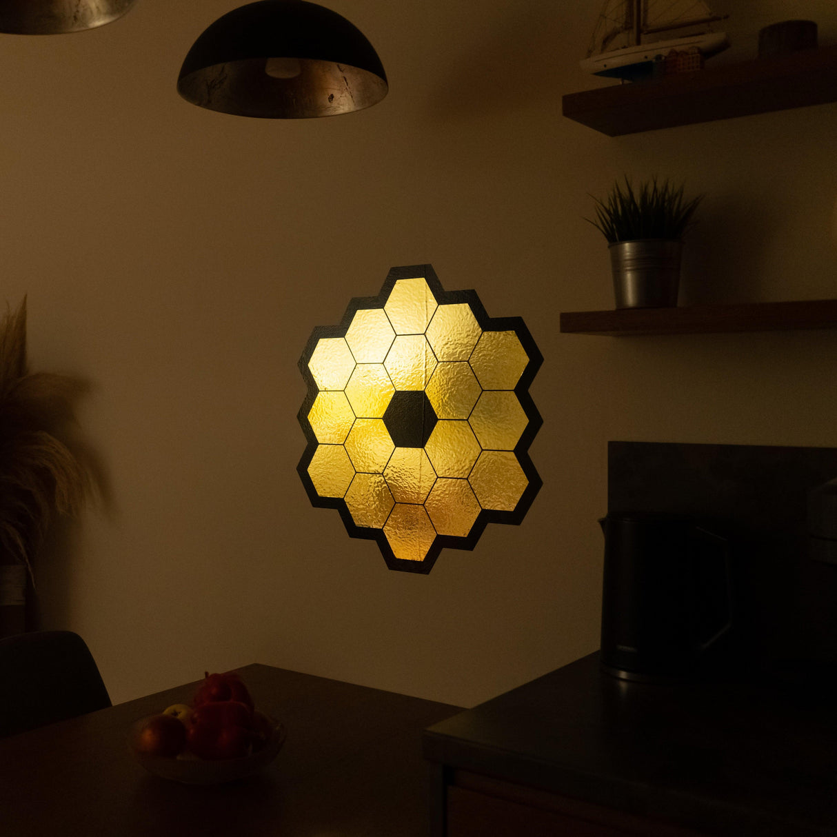 James Webb Space Telescope mirror wall sticker in gold chrome vinyl illuminating a modern kitchen