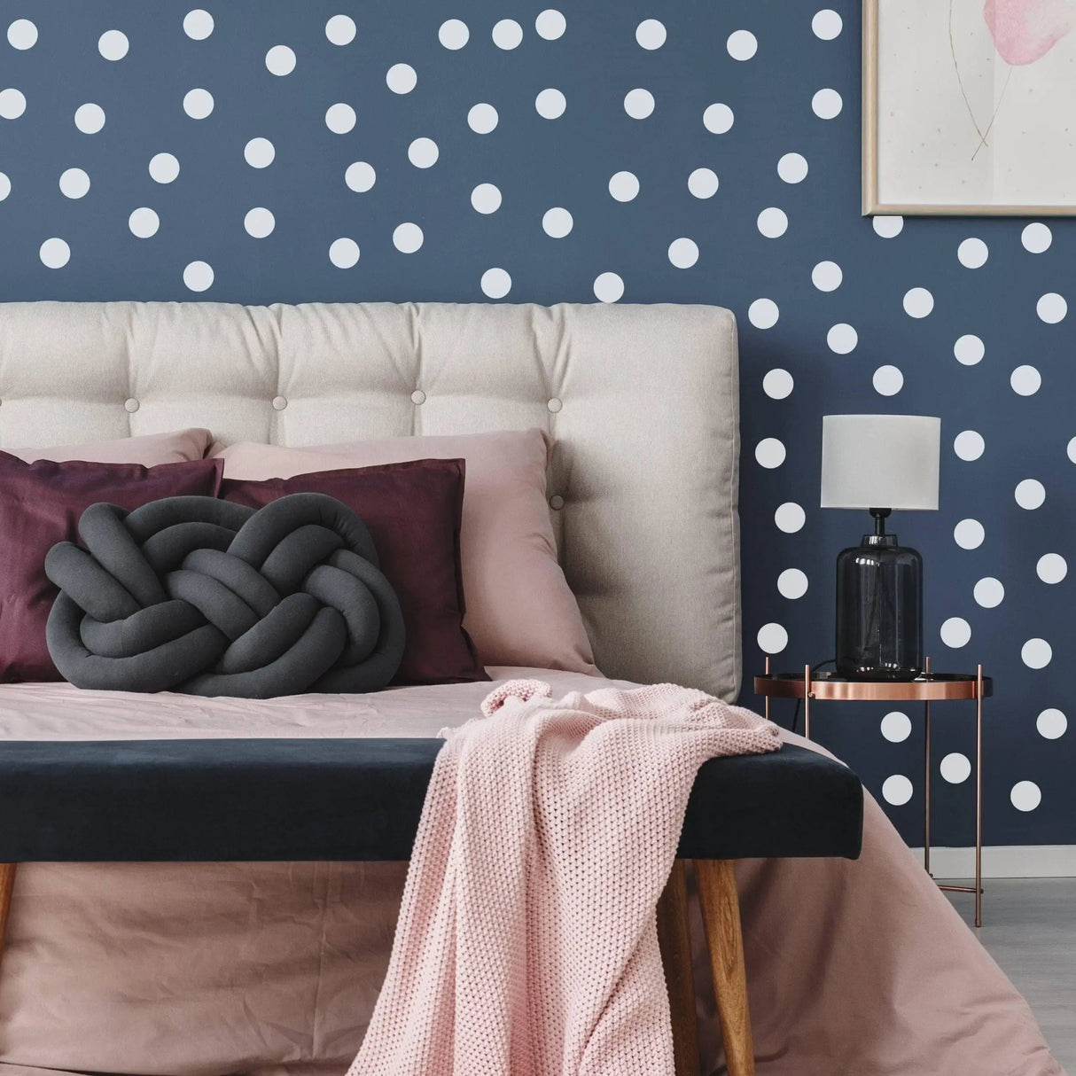 Cozy bedroom featuring white round circle dot stickers on navy wall, creating a creative and stylish decor.