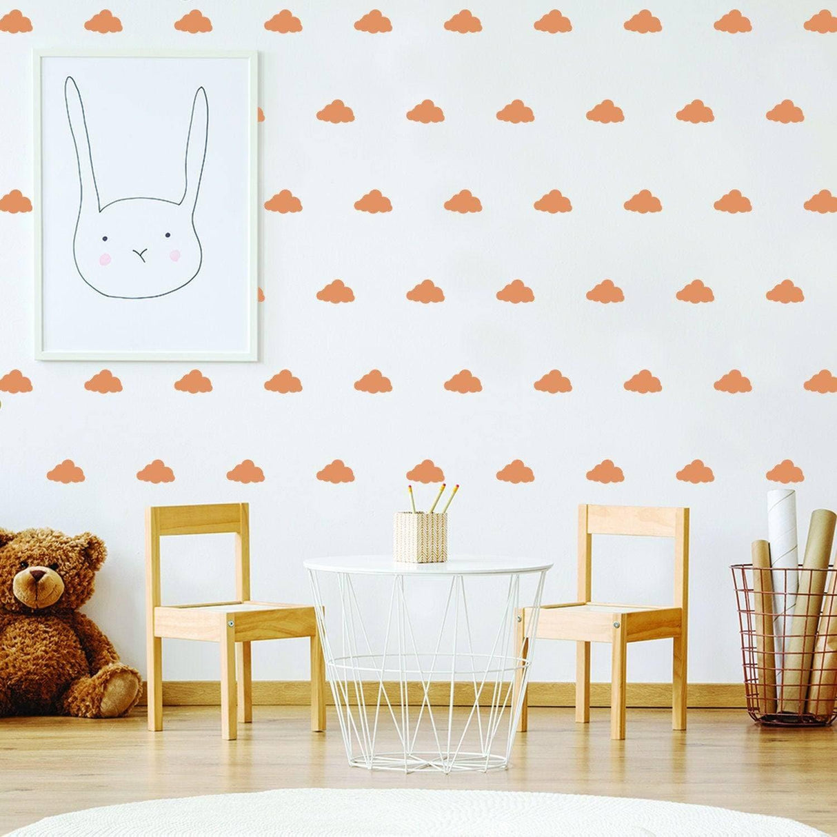 WhimsiCloud children's wall stickers in a nursery with orange cloud decals on the wall and a cute bunny illustration.