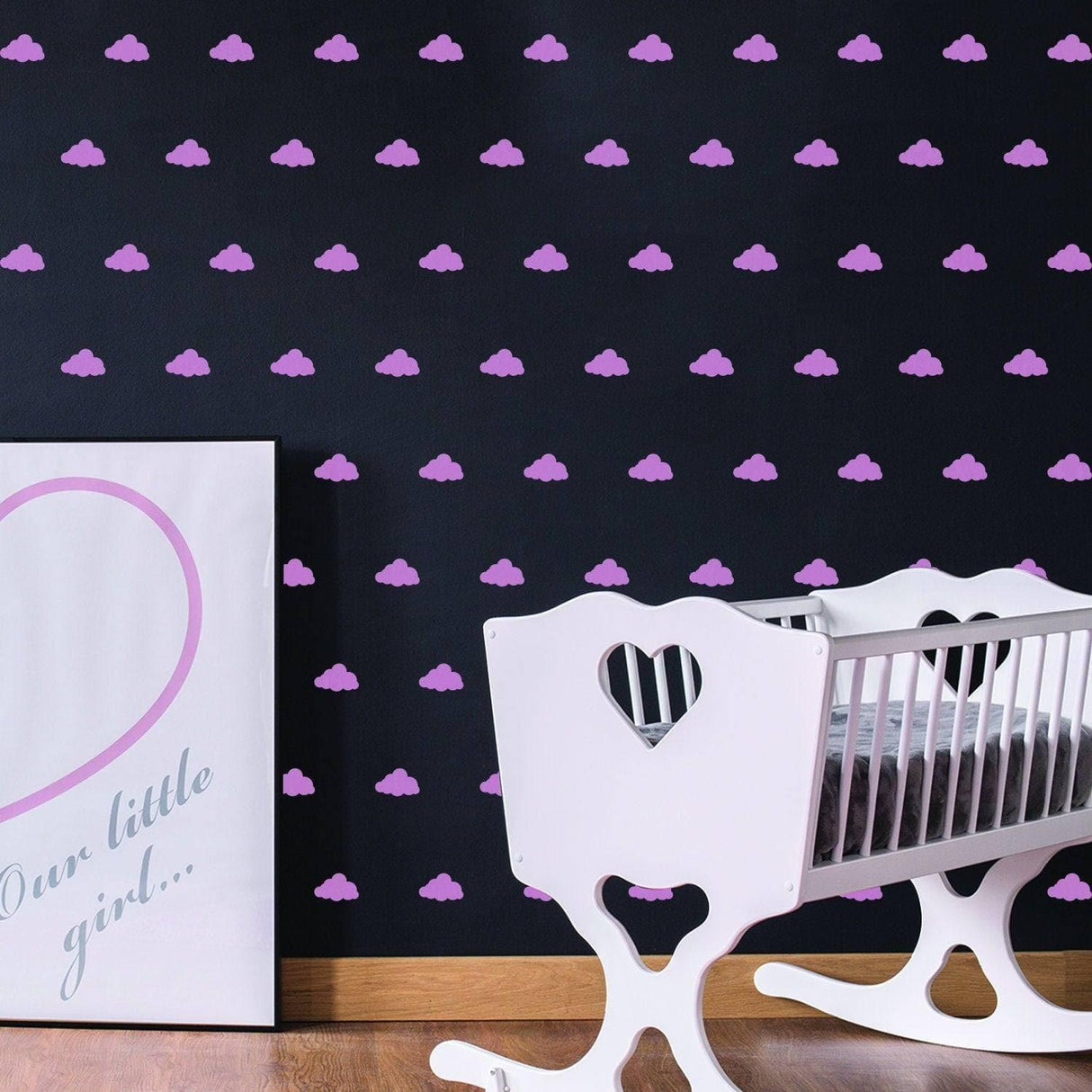 WhimsiCloud children's wall stickers in a nursery with pink clouds on a black wall, featuring a white rocking crib.