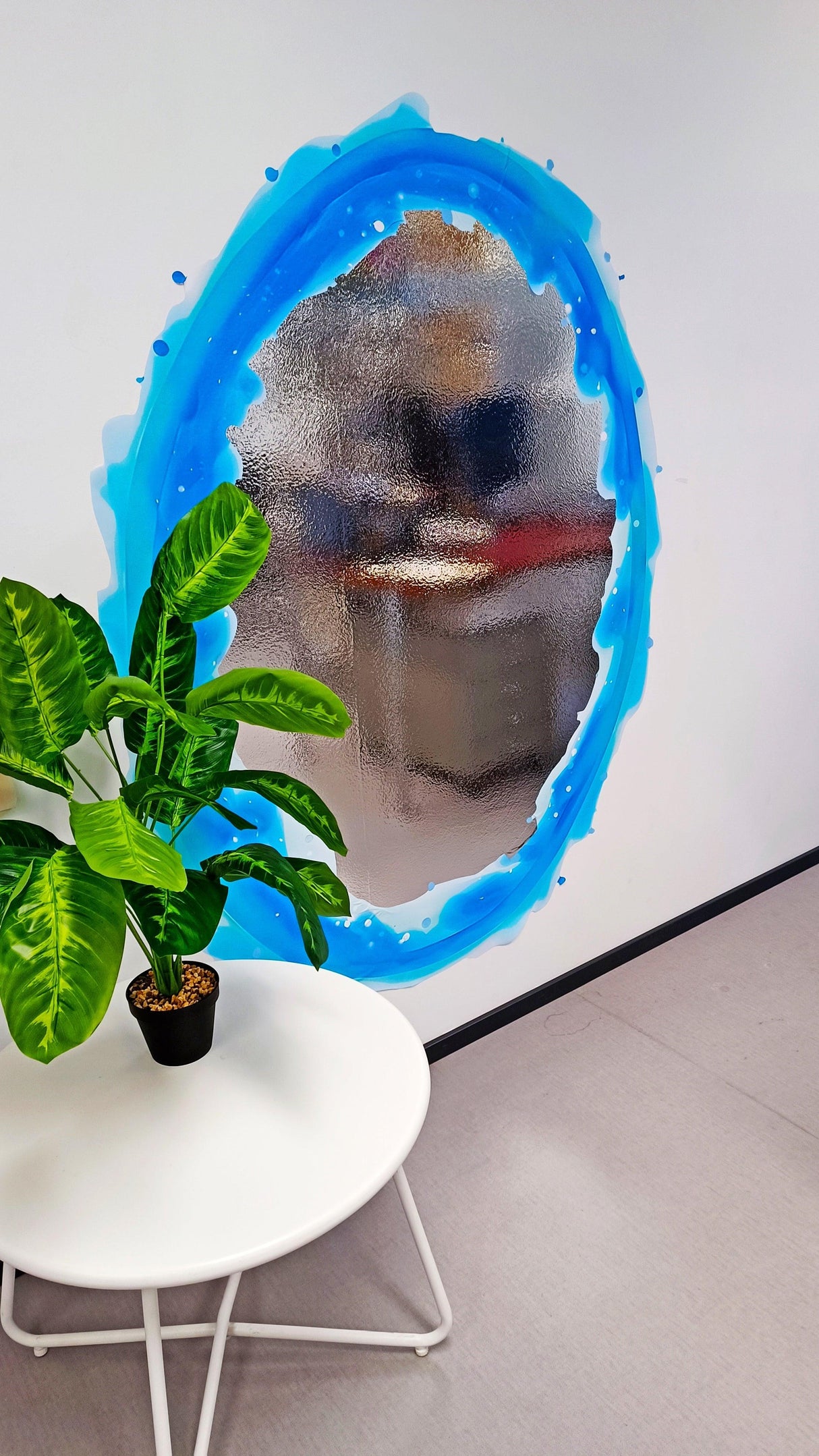 Vibrant blue aura portal wall sticker with silver chrome effect, enhancing modern decor in a gaming room.