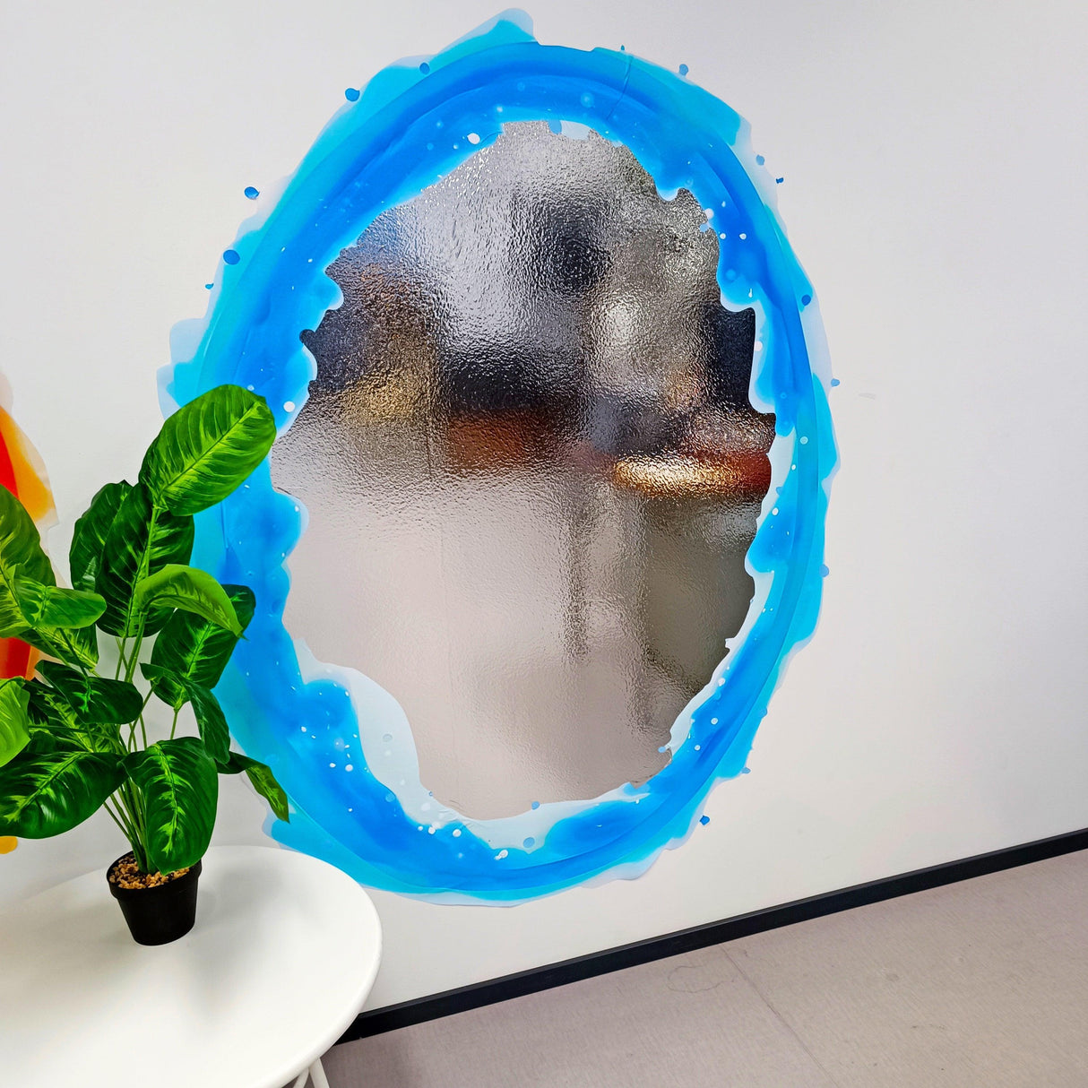 Blue portal aura wall sticker with silver chrome mirror effect, enhancing a modern room decor.