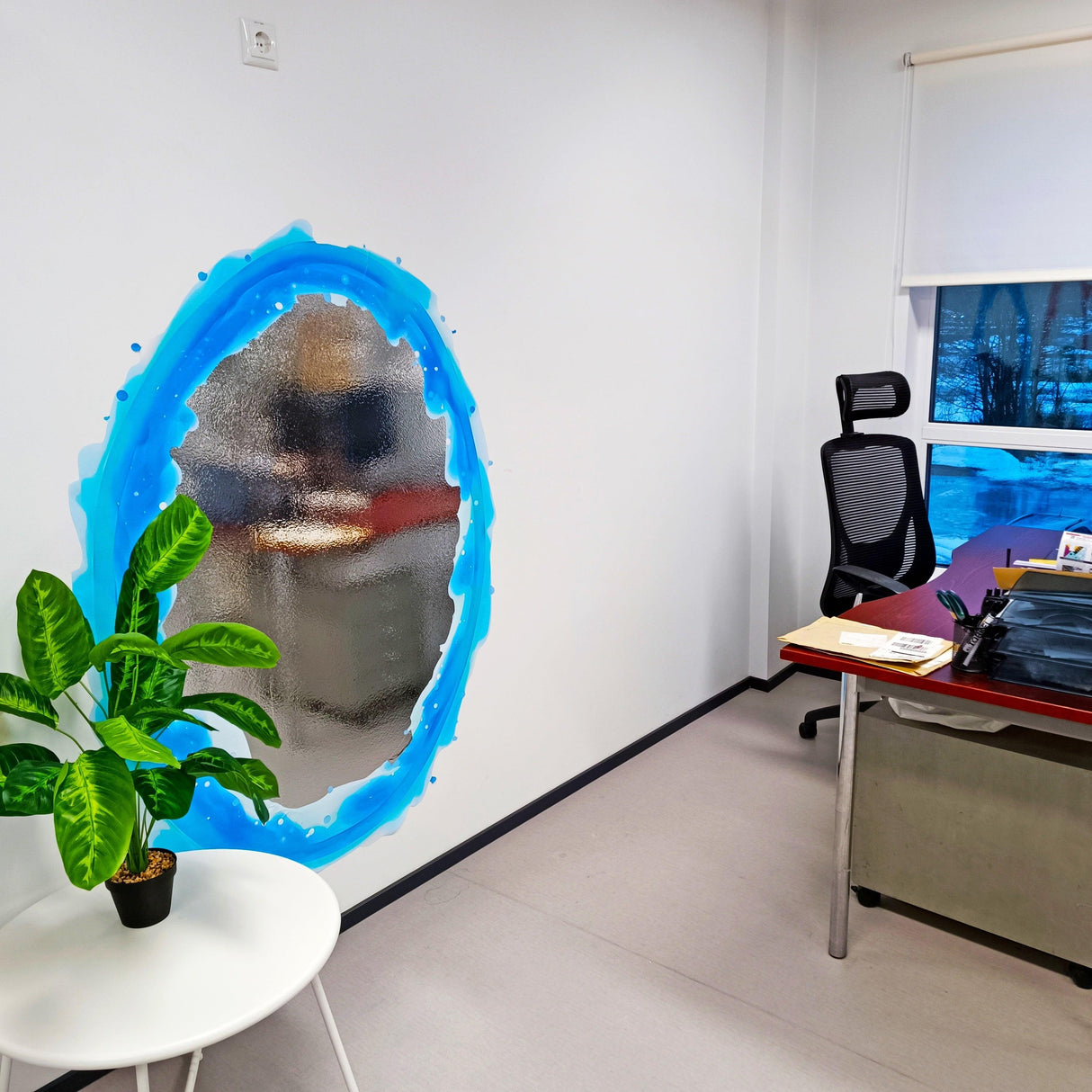 Blue and orange portal aura wall sticker with silver chrome effect in a modern office setting