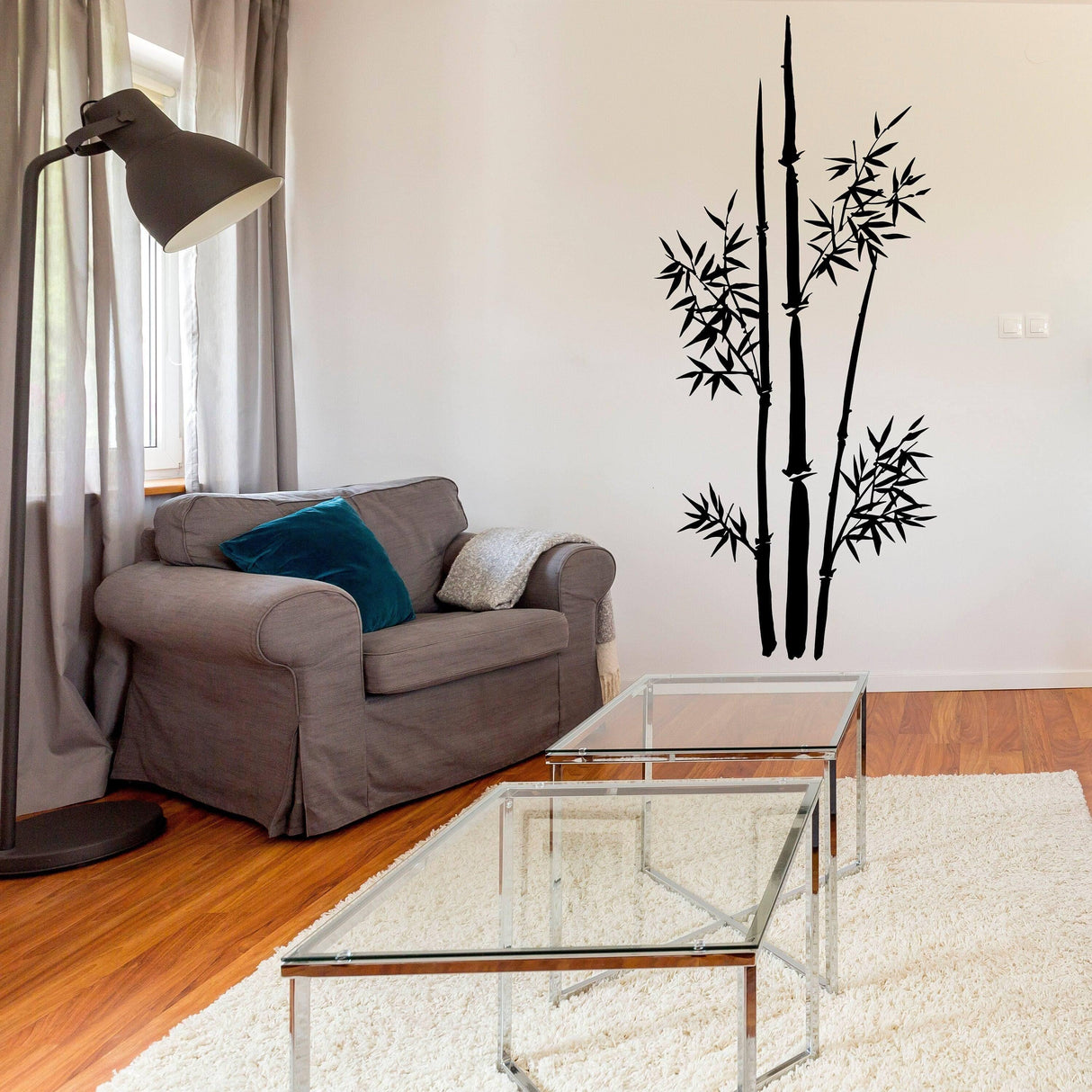 Bamboo wall art sticker in a cozy living room with a gray couch and glass coffee table.