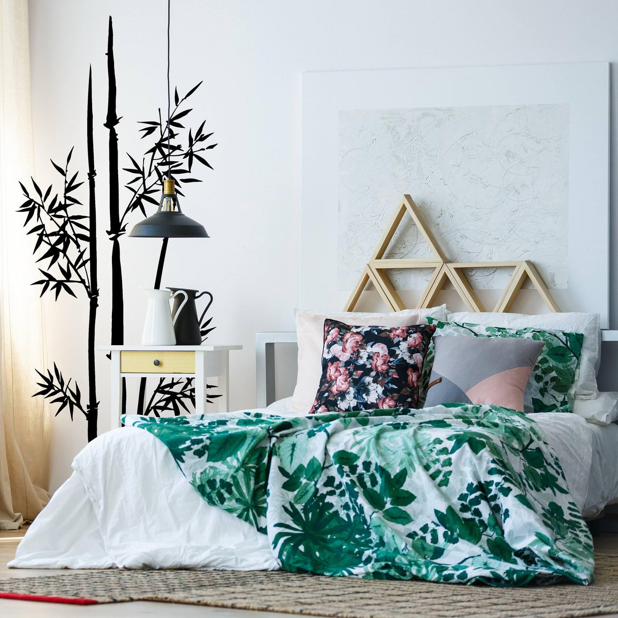 Bamboo wall vinyl decal in a modern bedroom with green bedding and floral pillows, enhancing natural decor.