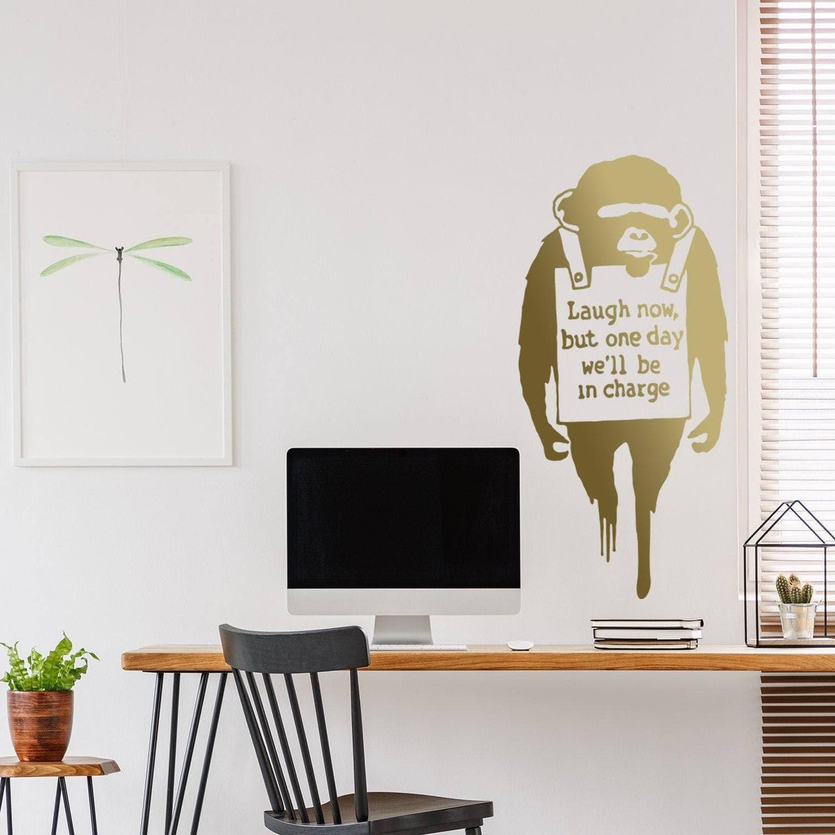 Banksy inspired monkey wall sticker with text 'Laugh now, but one day we'll be in charge' in modern home office.