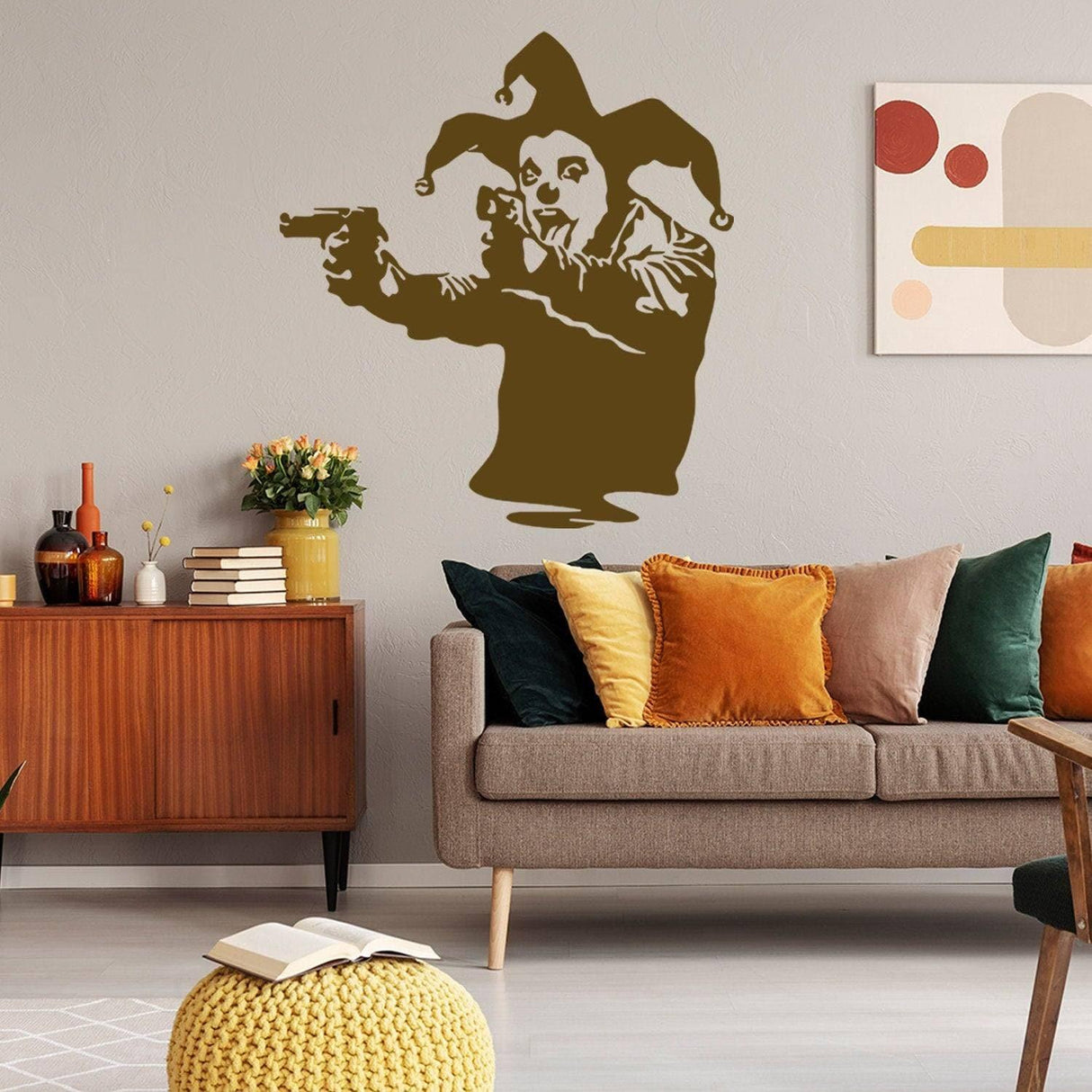 Joker Clown vinyl wall decal with gun theme on living room wall, stylish street art decor for modern interiors.