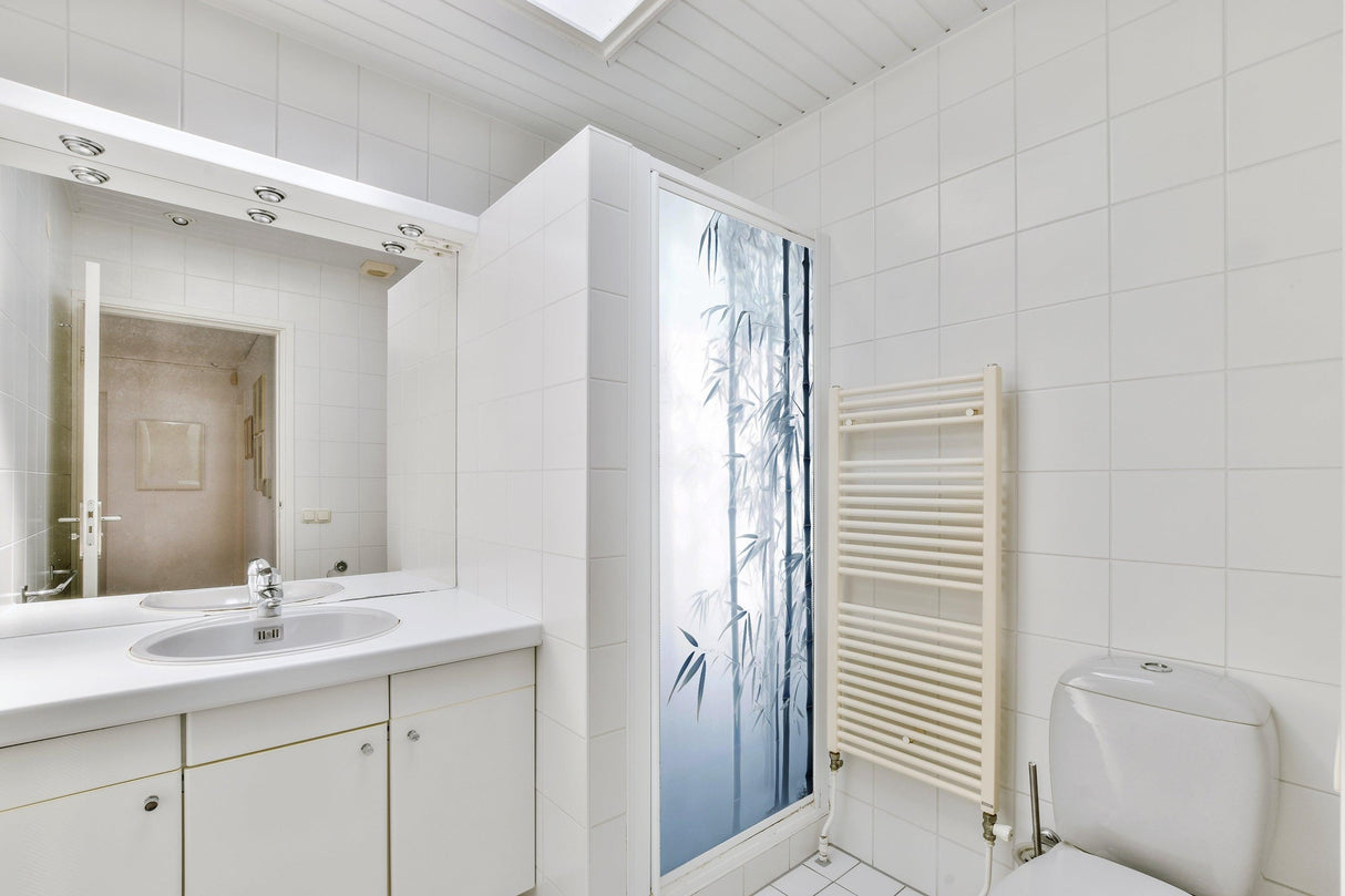 Bathroom featuring a tranquil bamboo forest shower door decal for enhanced privacy and serenity.