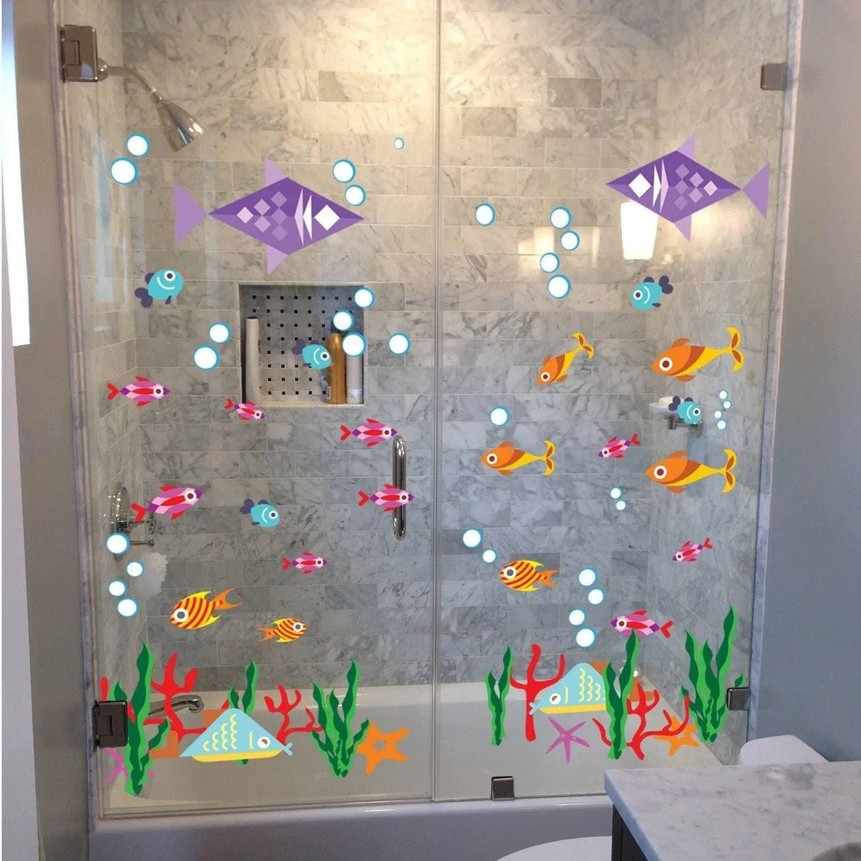 Colorful fish and bubbles vinyl decals on a shower door, creating a fun underwater scene for bathroom decor.