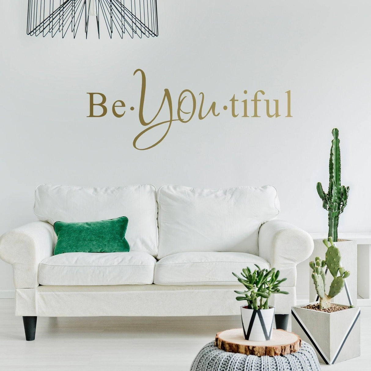 Motivational wall decal 'Be You tiful' in a stylish modern living room with plants and white sofa.