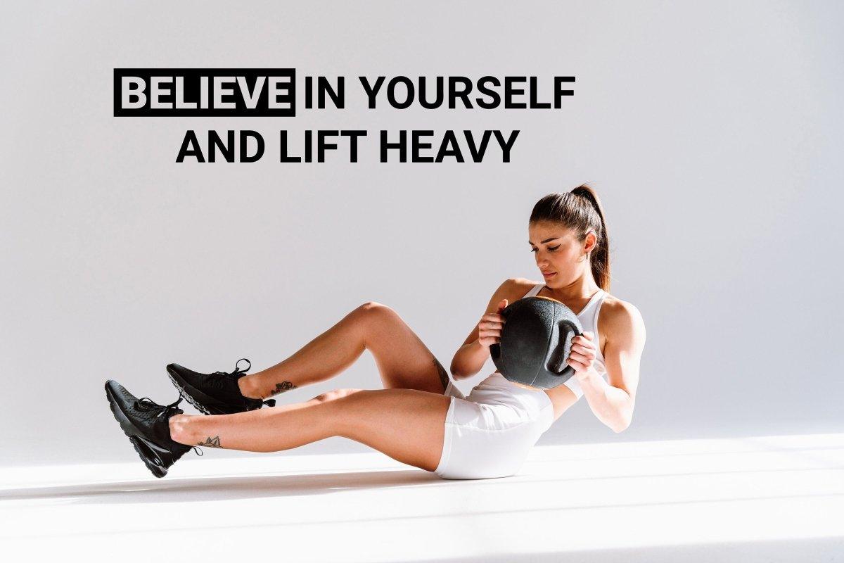 Motivational gym wall decal saying 'Believe in Yourself and Lift Heavy', featuring a woman exercising with weights.