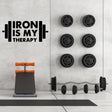 Inspirational gym wall art decal 'Iron is My Therapy' above weights and workout bench in a modern gym setting.