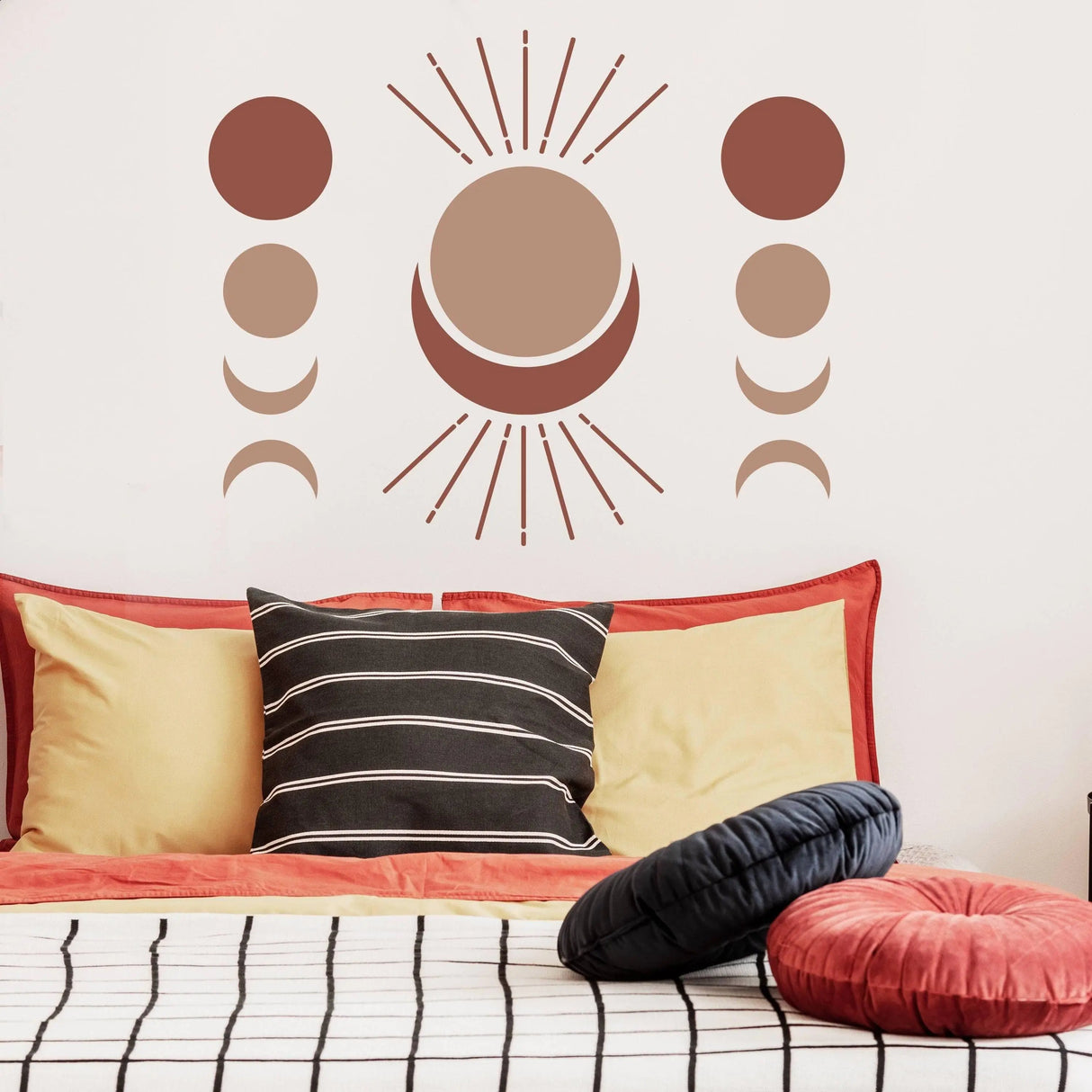 Bohemian crescent moon phases wall decal above a stylish bed with colorful pillows in a cozy room.
