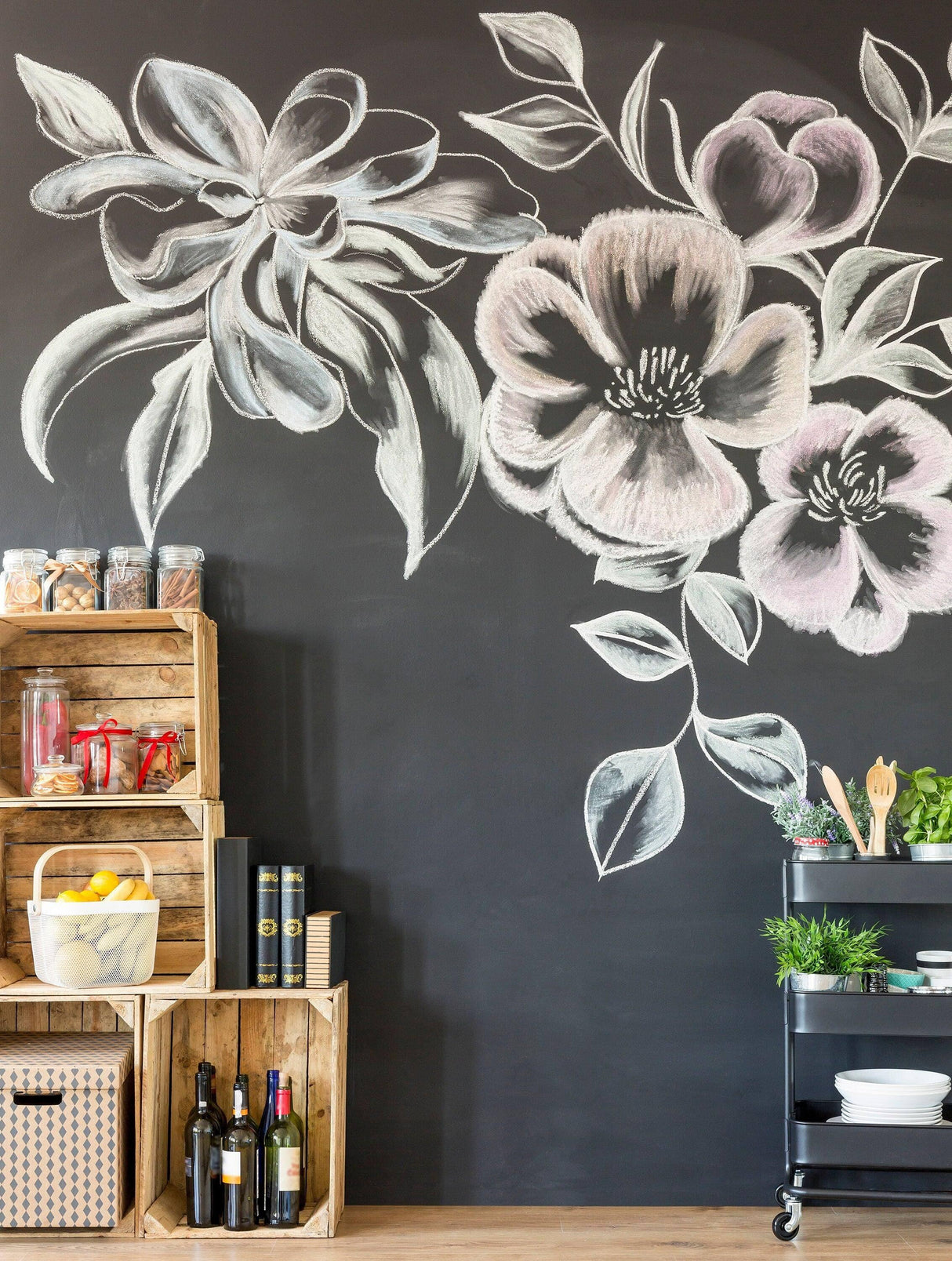 Beautiful chalk floral mural on a black wall with wooden crates and a cart of plants and drinks.