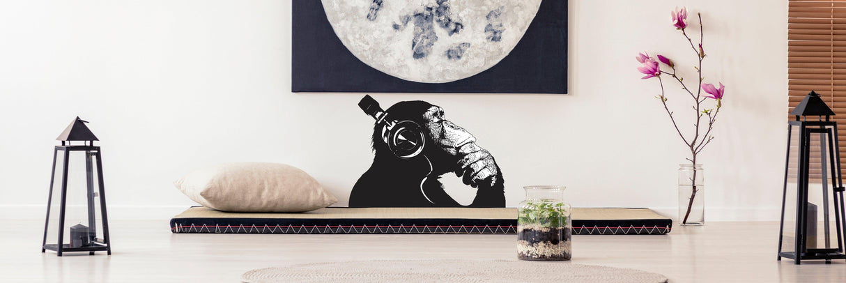 Cool thinking monkey wall sticker with headphones, enhancing modern decor and artistic vibe in a stylish room.
