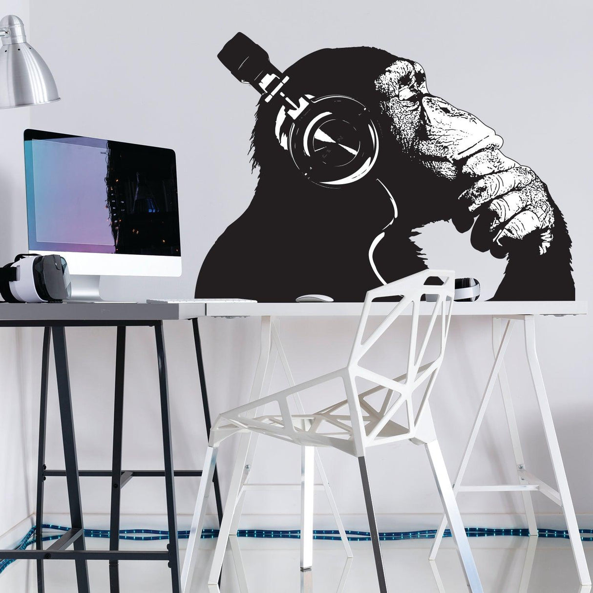 Vinyl wall art decal of a contemplative chimp wearing headphones, perfect for adding personality to any room.