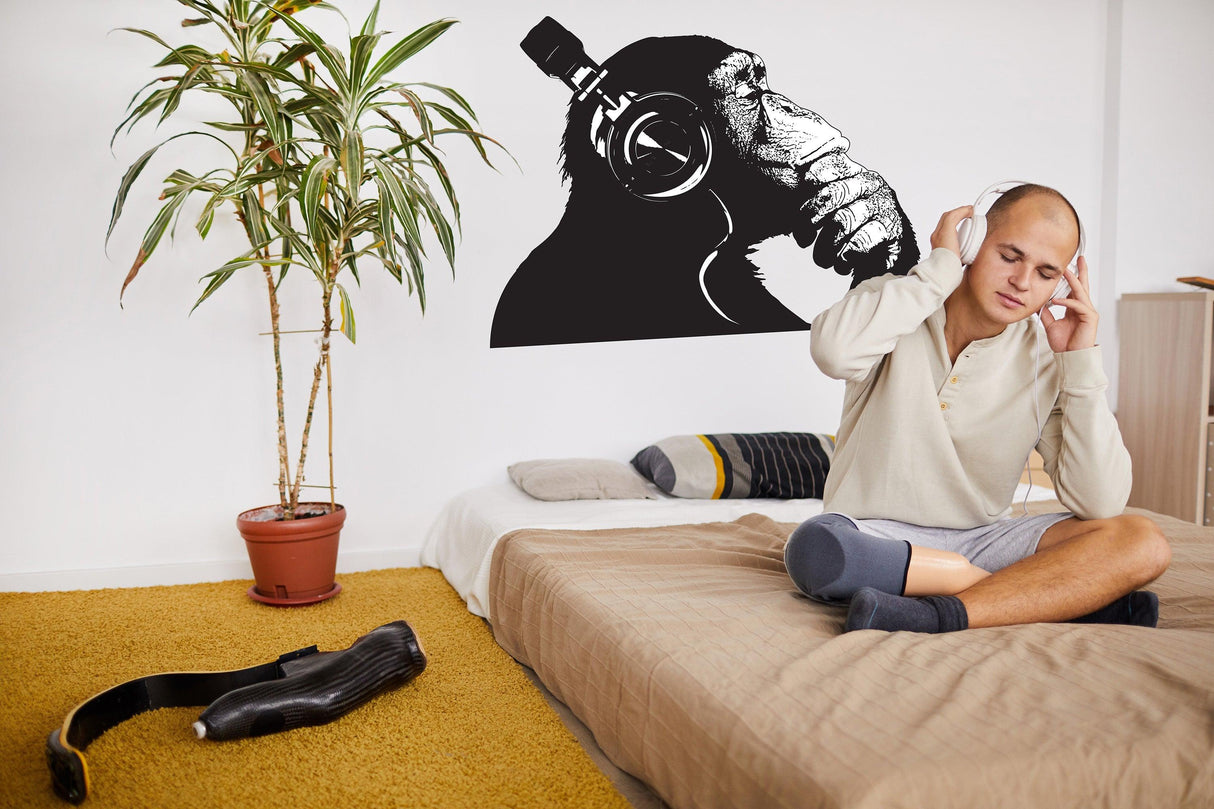 Cool thinking monkey wall sticker featuring a chimp with headphones, adding personality to a modern bedroom.