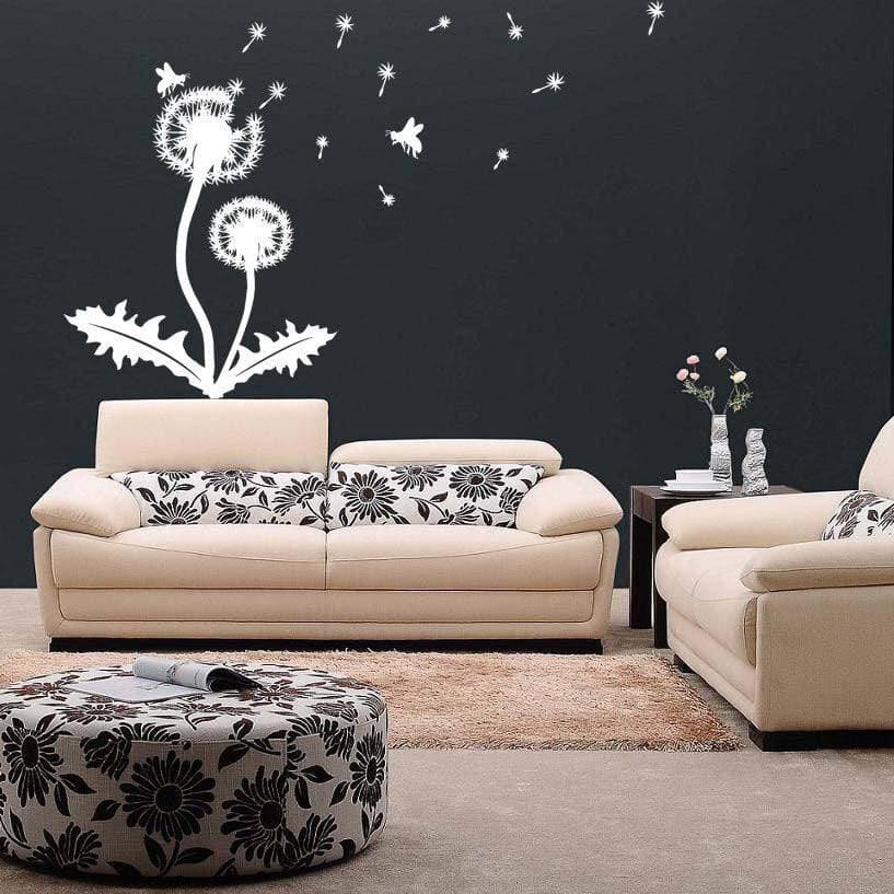 Vinyl sticker decal of dandelions and butterflies on a dark wall in a stylish living room with floral decor.