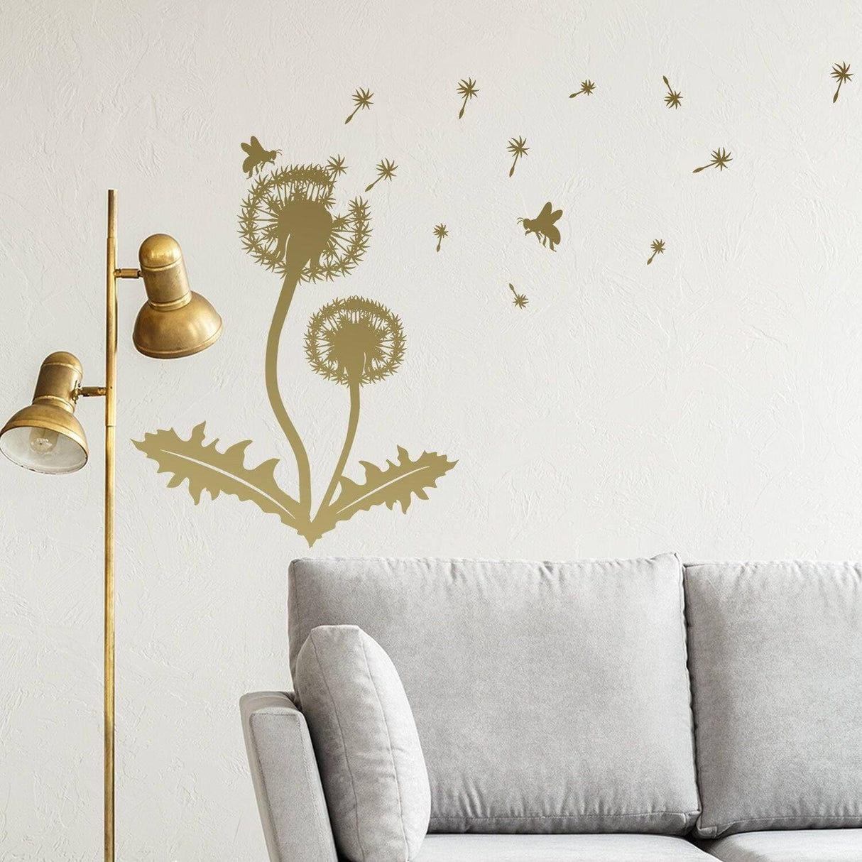 Dandelion vinyl sticker wall decal featuring botanical design on wall above gray sofa with standing lamp.