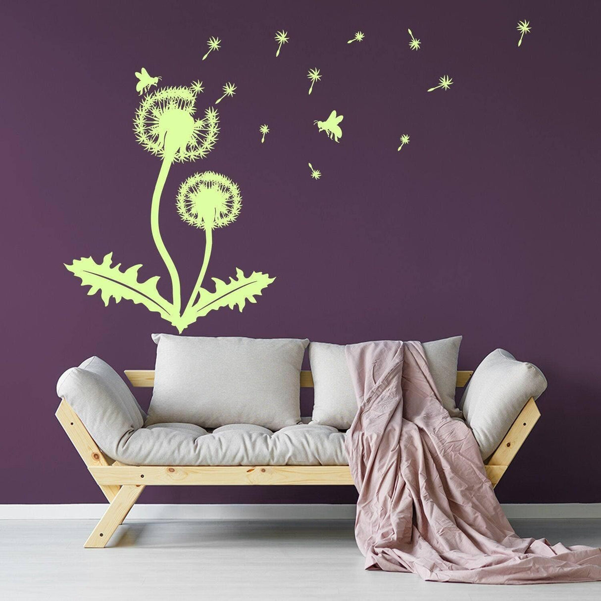 Dandelion vinyl sticker decal on dark wall above a cozy sofa, adding a nature-inspired touch to home decor.