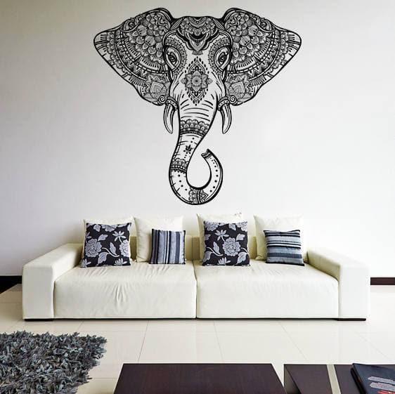 Whimsical elephant wall art decal above a stylish white couch, adding charm and elegance to home decor.