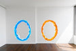 Blue and orange portal aura wall stickers on white walls, perfect for game room decor.