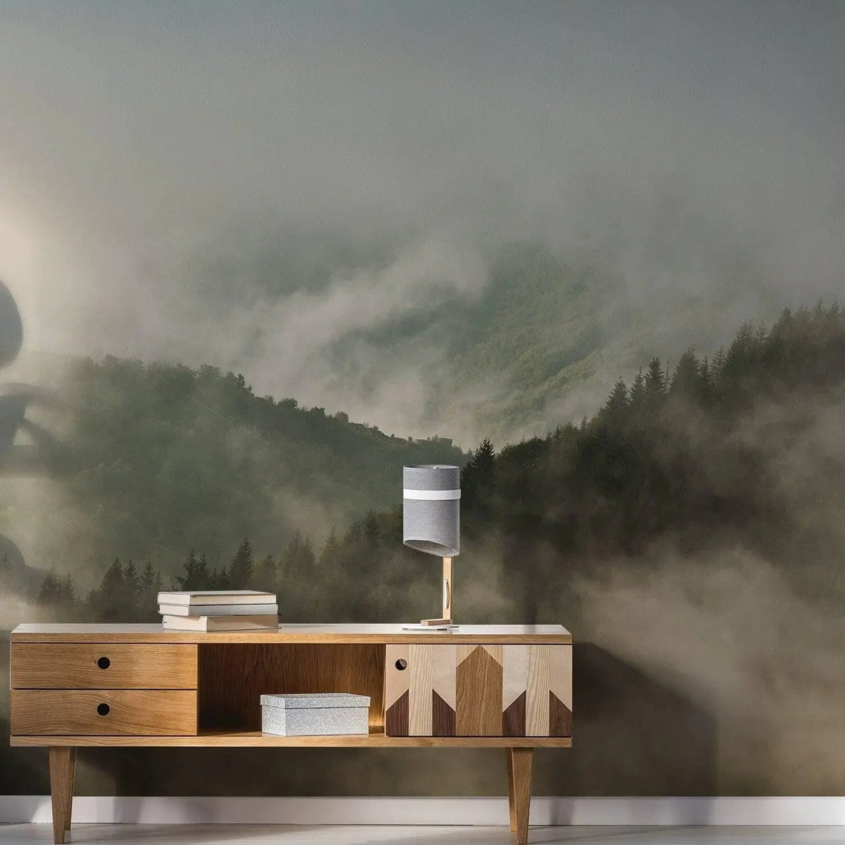 Misty Pine Hill Dreamscape wallpaper mural featuring fog-covered mountains and modern wooden furniture.