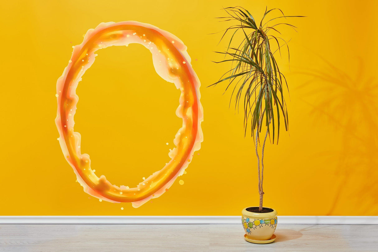 Vibrant orange portal aura wall sticker on yellow wall, enhancing gamer room decor with lively colors.