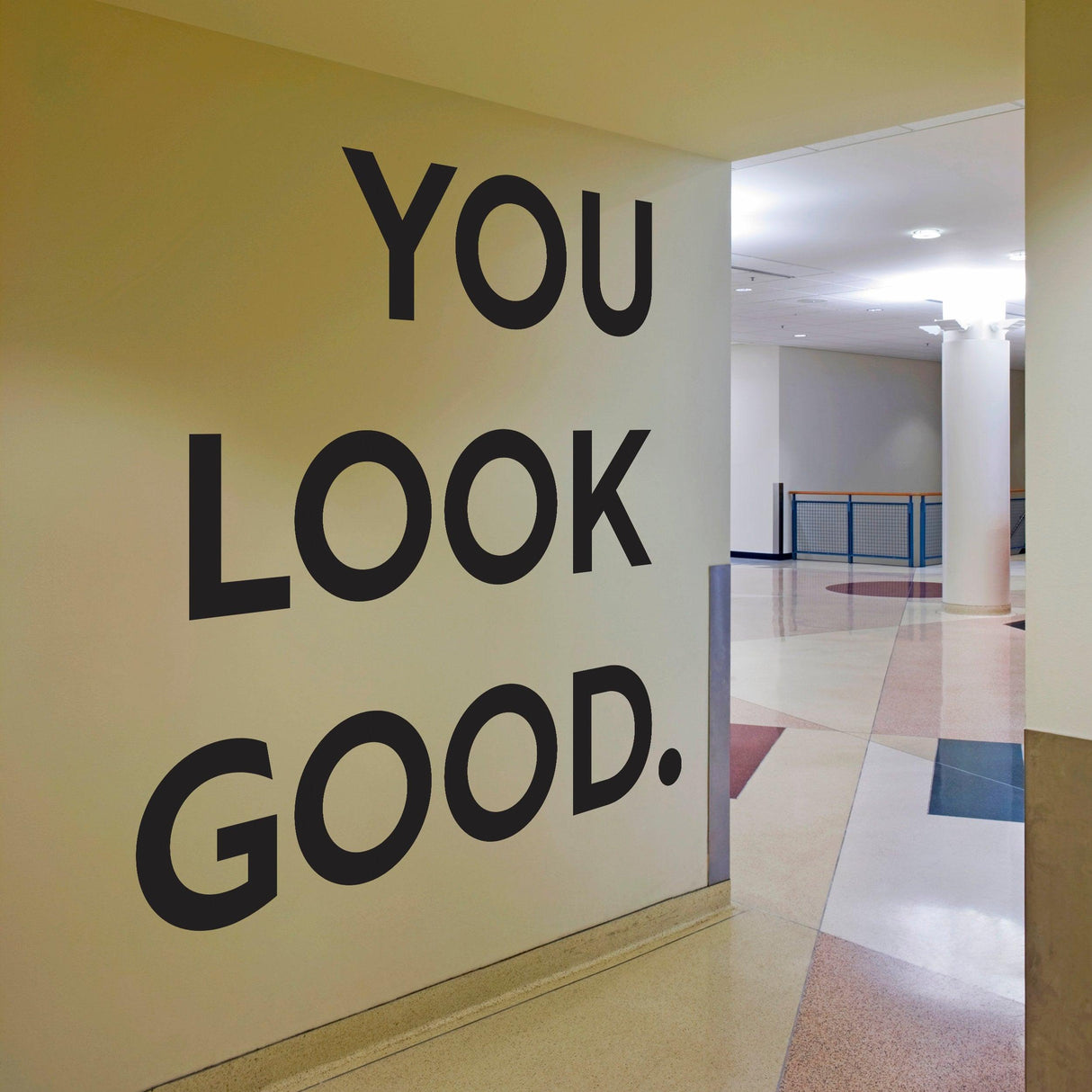 You Look Good vinyl wall sticker displayed on a wall in a hallway, featuring bold inspirational text.