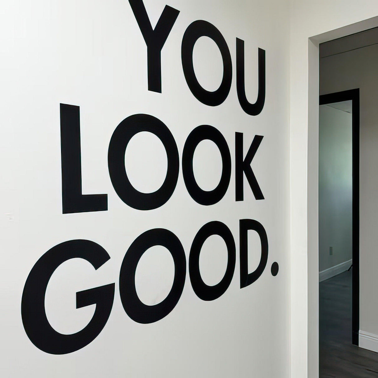 Inspirational wall decal saying 'You Look Good' in bold black letters on a white wall.