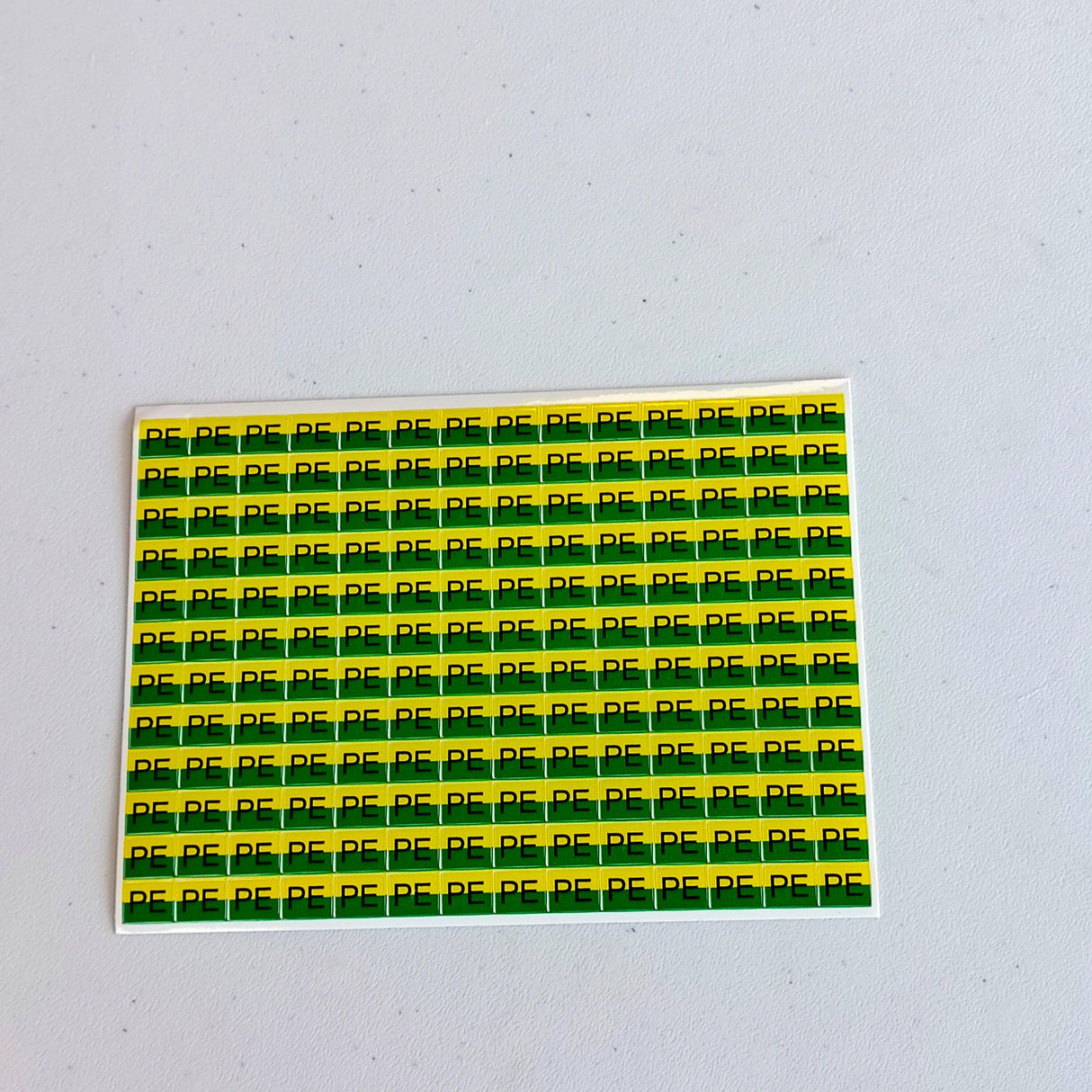 Pack of yellow and green PE electrical component labels for safety and organization of electrical systems.