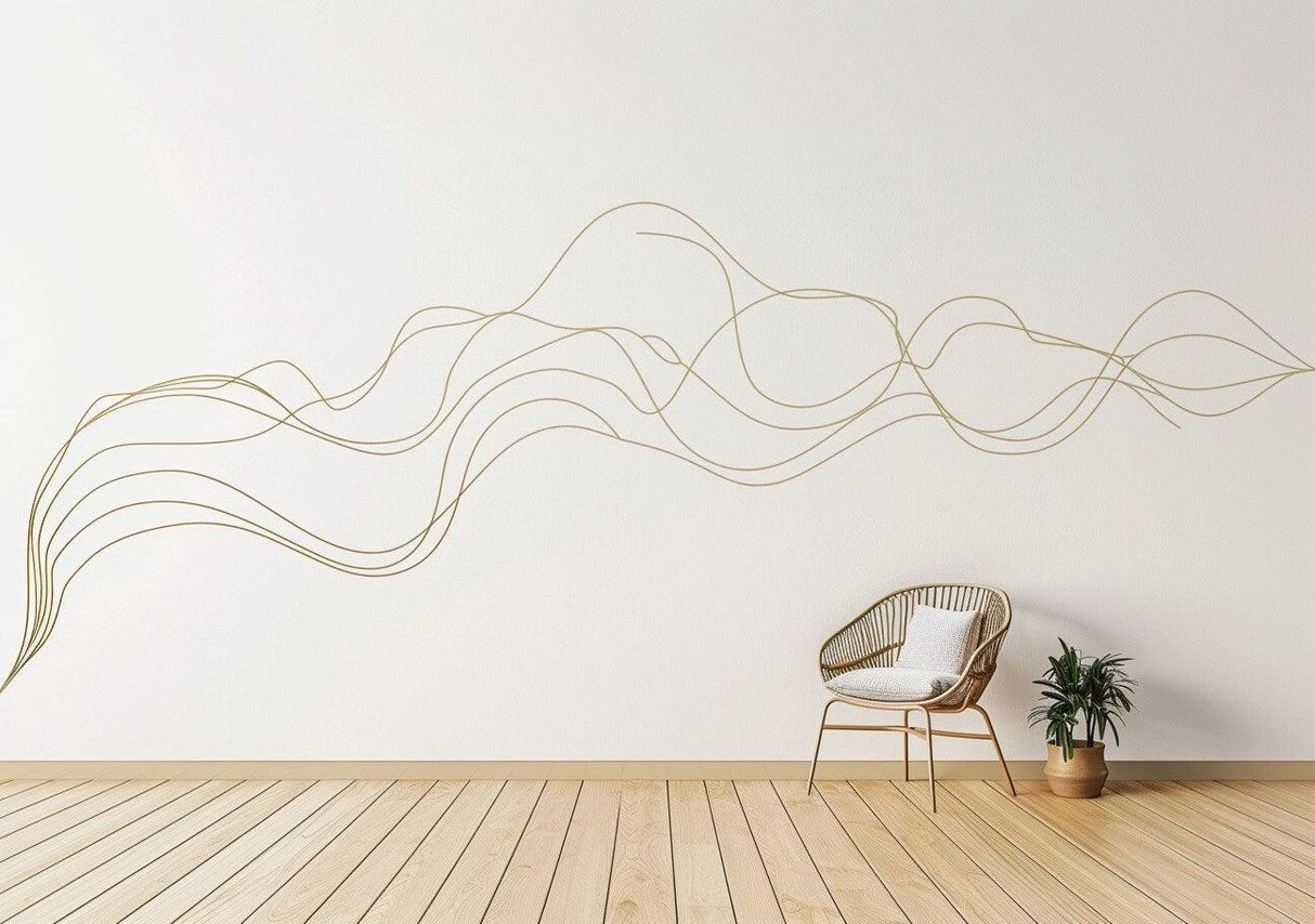 Elegant gold line art wall sticker design above a chair, enhancing minimalist home decor with flowing patterns.
