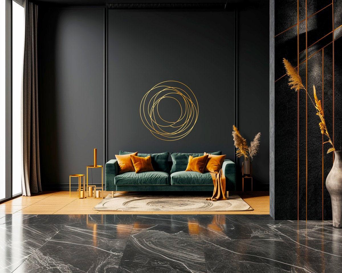 Elegant gold circle wall sticker above a green sofa in a modern living room with dark walls and stylish decor.