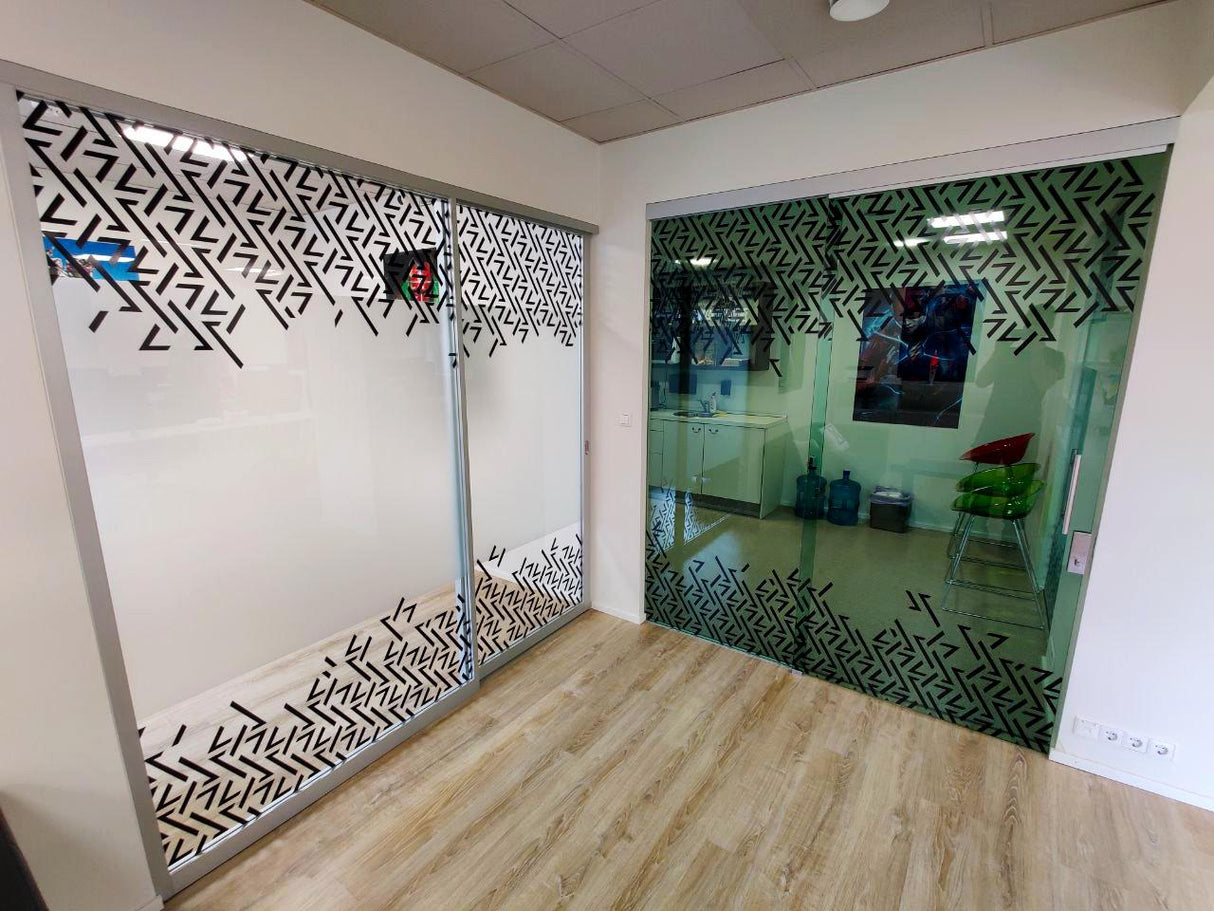 Custom etched mirror decals on office glass doors with decorative sandblasted design.