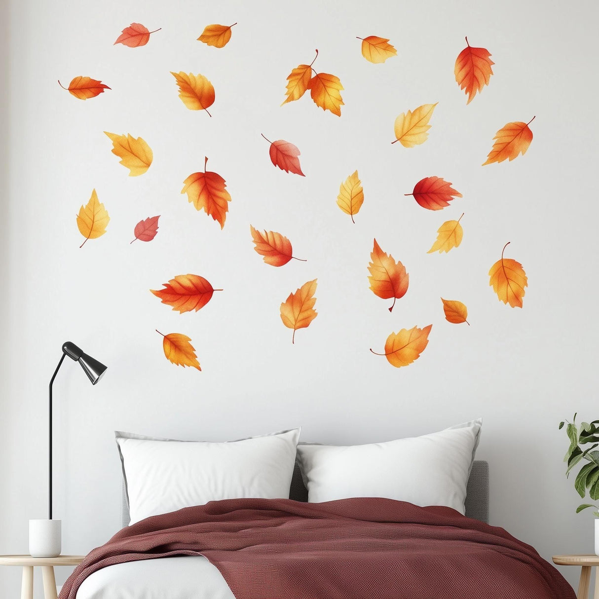 Wall displaying 25 autumn leaves decals in warm colors, enhancing cozy bedroom decor for fall.
