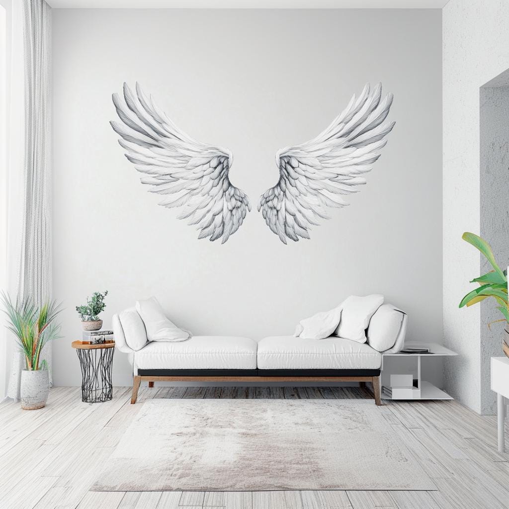 Large angel wings wall decal on a light wall above a modern sofa, adding elegance and serenity to the living space.