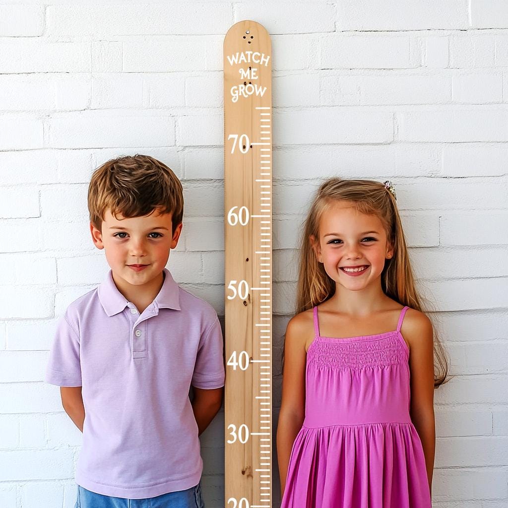 Two children stand beside a wooden growth chart decal, featuring height markings and the phrase 'Watch Me Grow'.