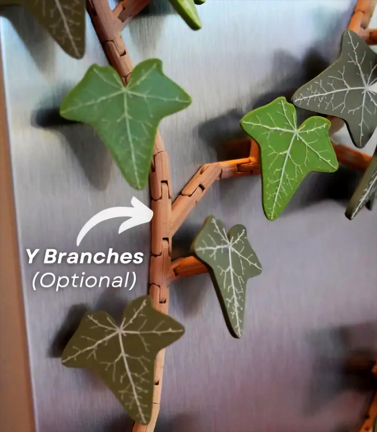 Close-up of customizable green ivy fridge magnet branches on stainless steel, showcasing articulated design and Y branches.