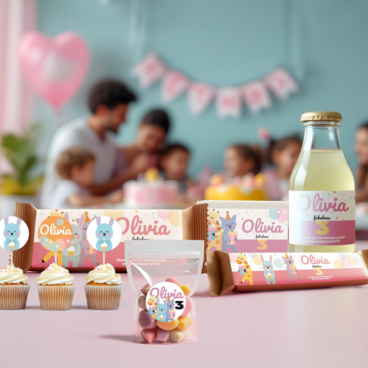 Personalized kids party setup with animal theme decorations, cupcakes, and custom name labels for Olivia's birthday.