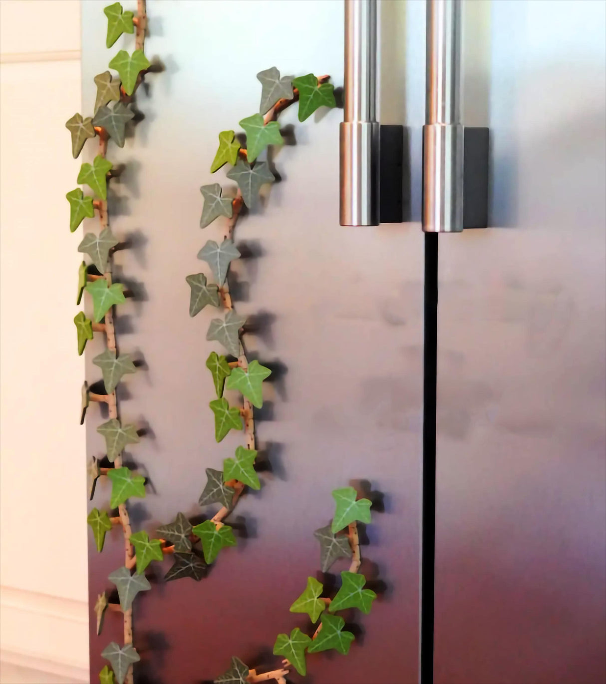 Custom color ivy fridge magnet decoratively arranged on a stainless steel refrigerator door.