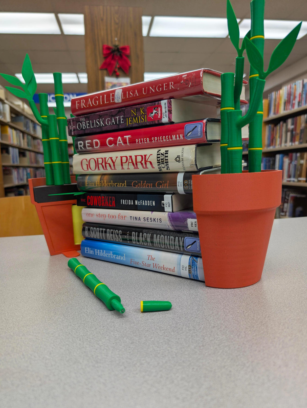 Bamboo bookends with books and stationery on a table, enhancing desk organization and decor.