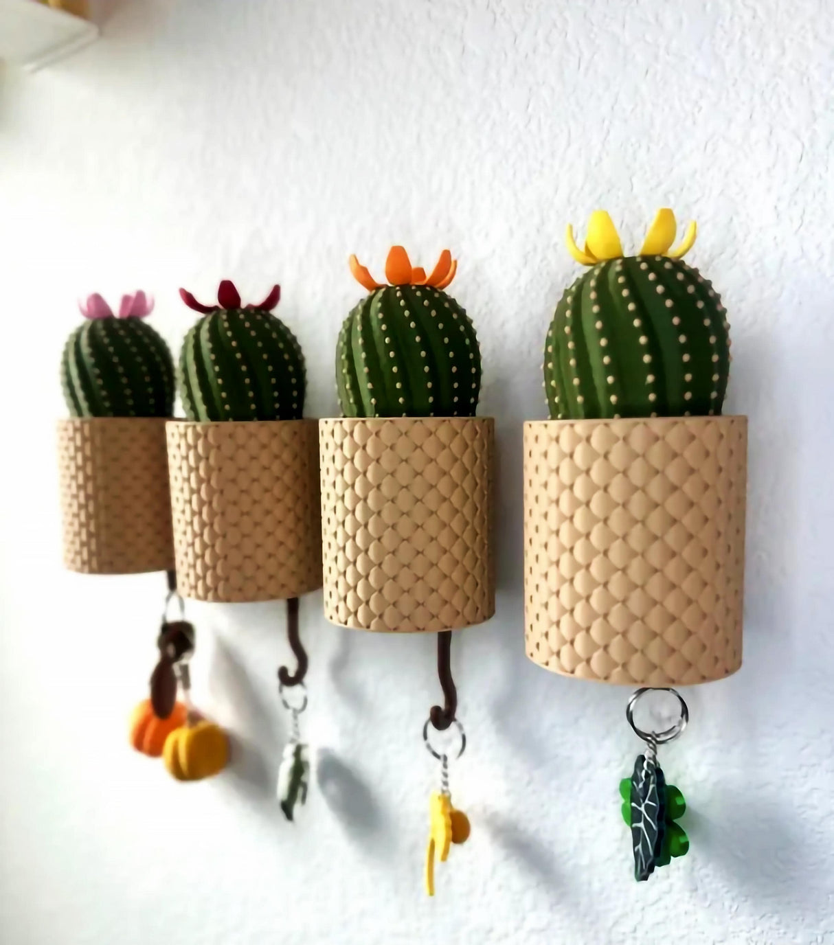 Blooming wall-mounted key holder with cacti design, featuring colorful flowers and functional key storage.