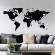 Modern black vinyl world map wall decal in a stylish living room setting.