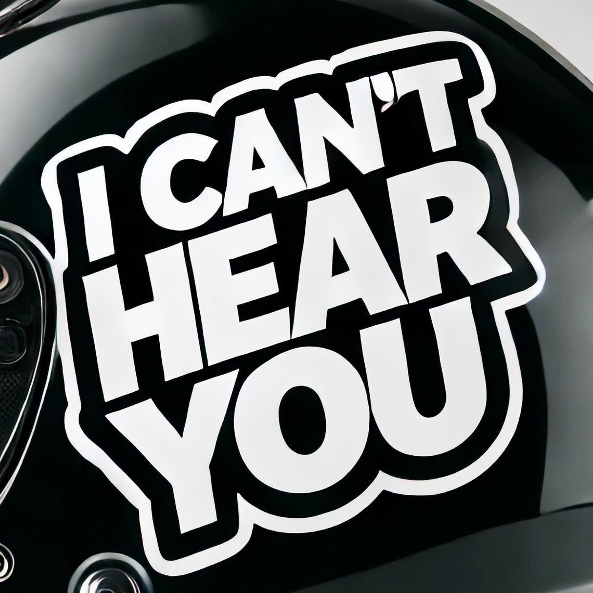 I Can't Hear You helmet sticker on a black motorcycle helmet, bold white vinyl decal for bikers.