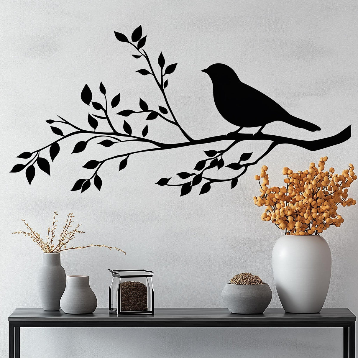 Silhouette of a bird perched on a tree branch wall decal, surrounded by elegant home decor accessories.