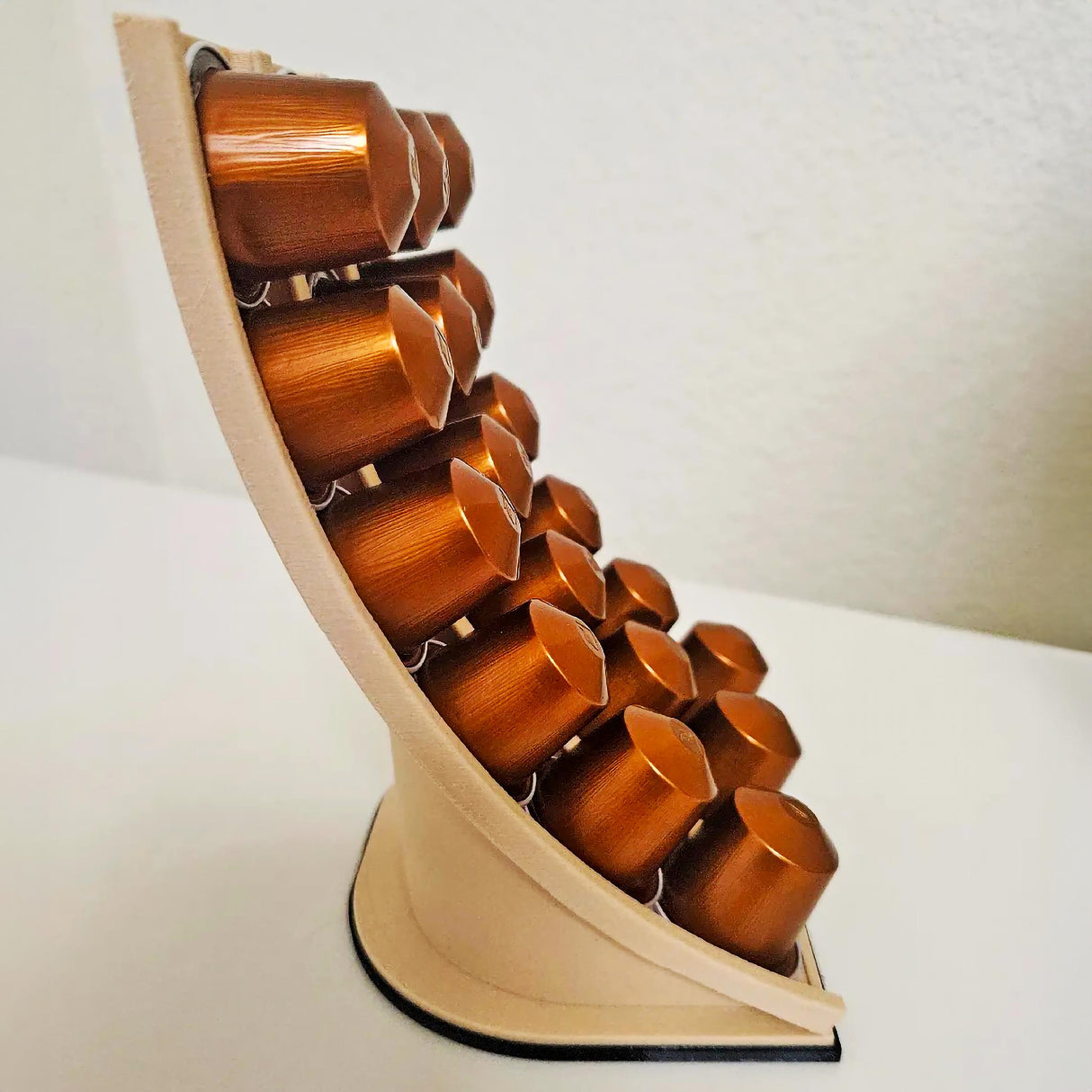 3D printed Nespresso coffee capsule holder displaying bronze coffee pods in a sleek design.