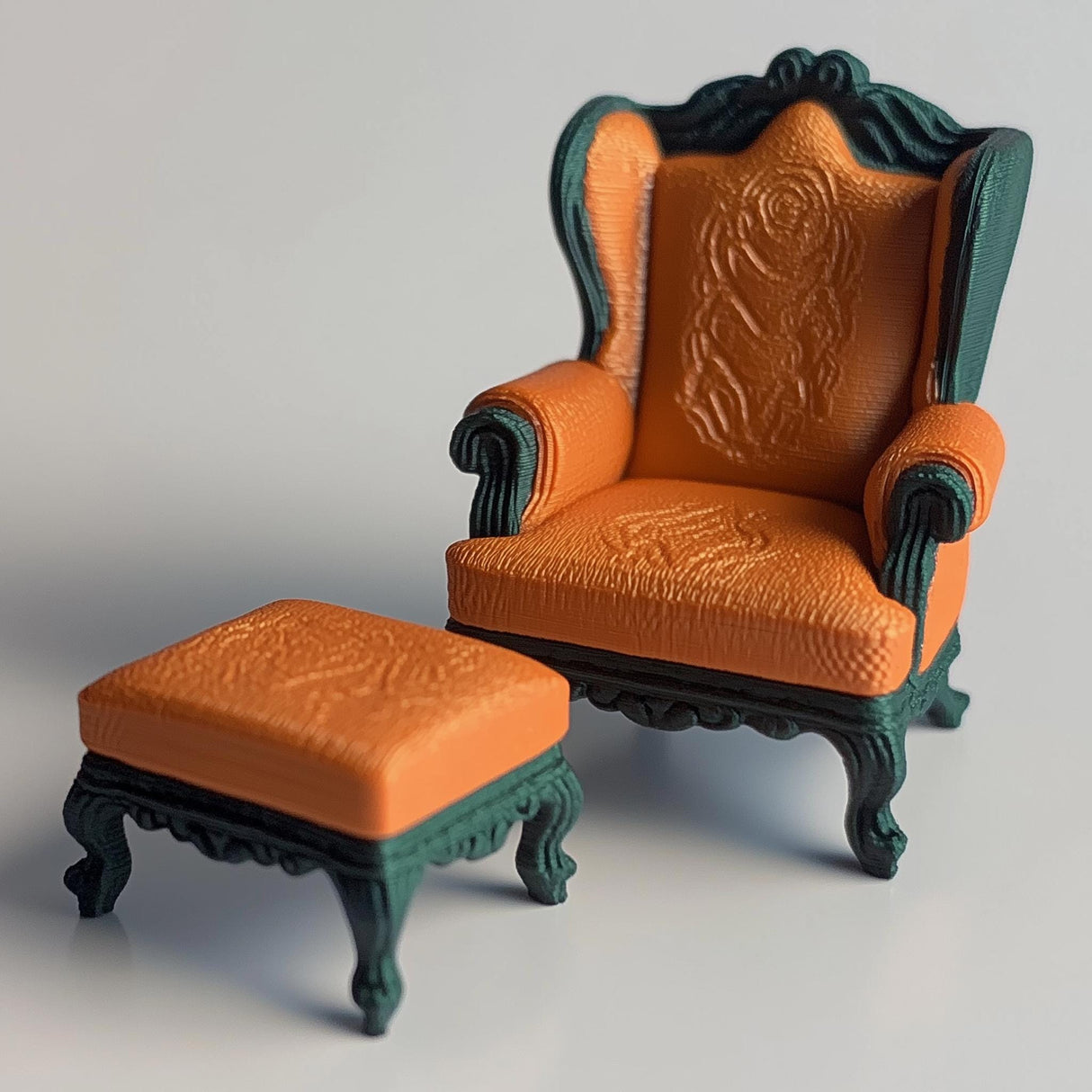 Baroque armchair and ottoman set in 1:12 scale, featuring ornate carvings and orange upholstery for dollhouse decor.