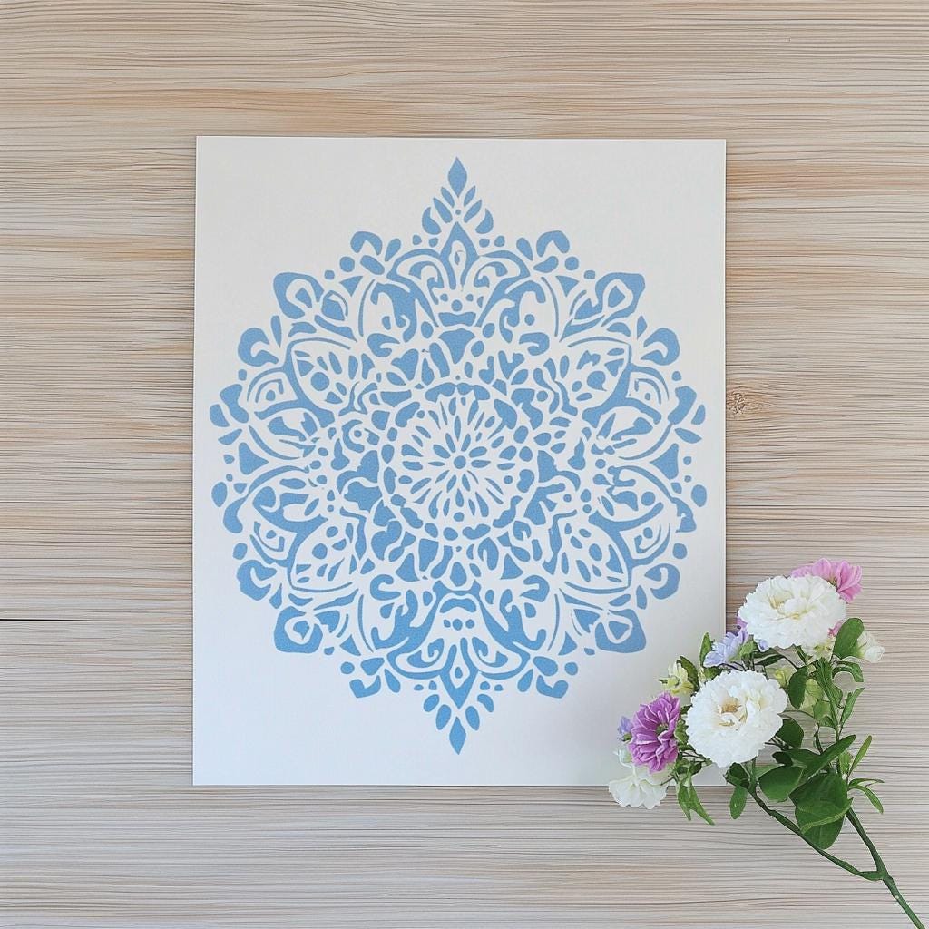 Intricate blue mandala stencil design on white paper, ideal for DIY projects and home decor.